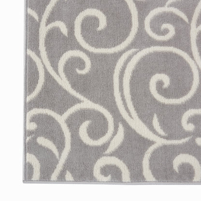 Gray rug with ivory swirl scroll pattern; soft plush pile, decorative floor covering.