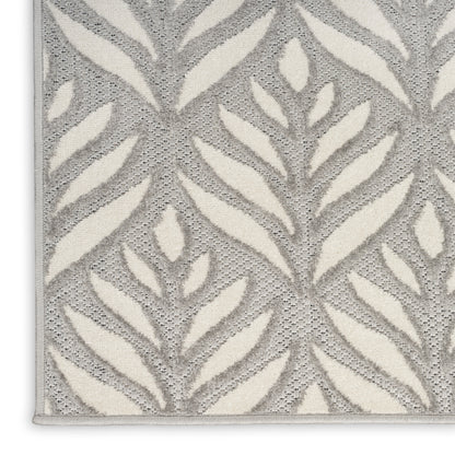 Grey and ivory leaf-patterned area rug with textured pile and bound edge.