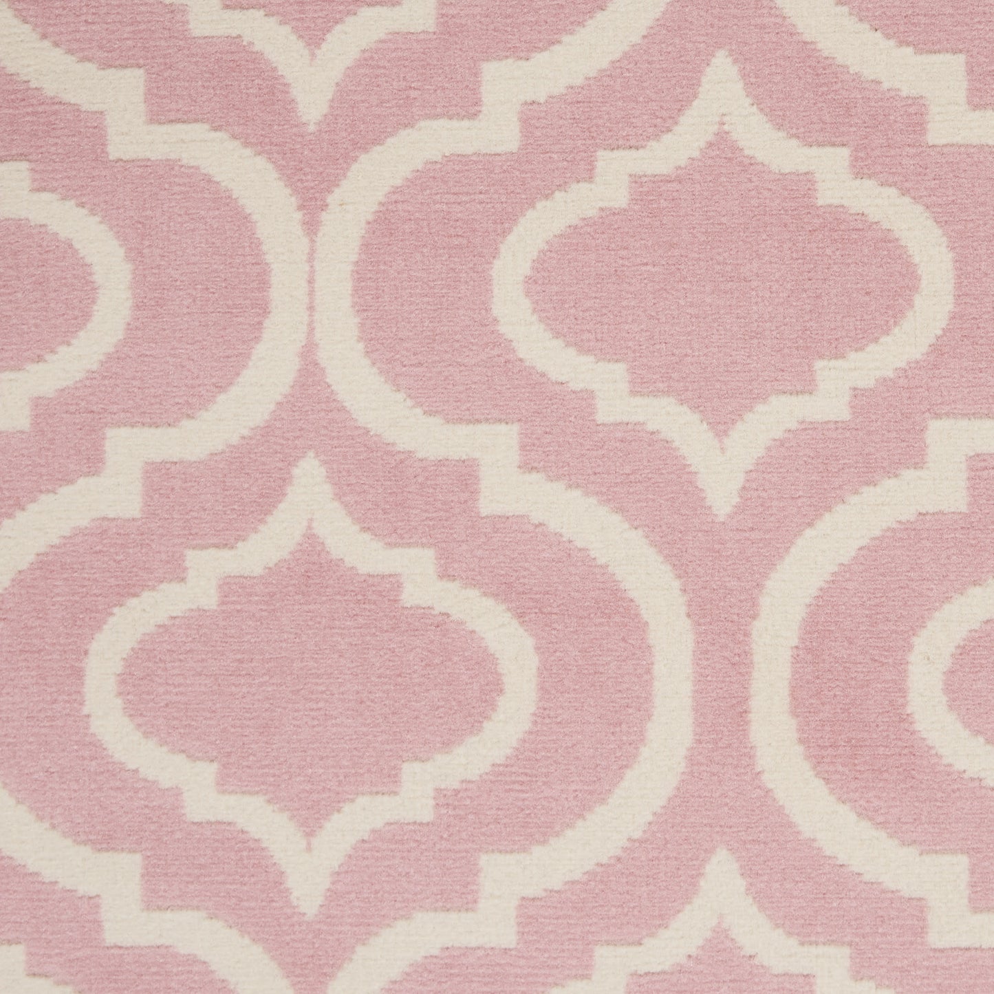 Pink rug with white geometric ogee lattice motif and woven texture.