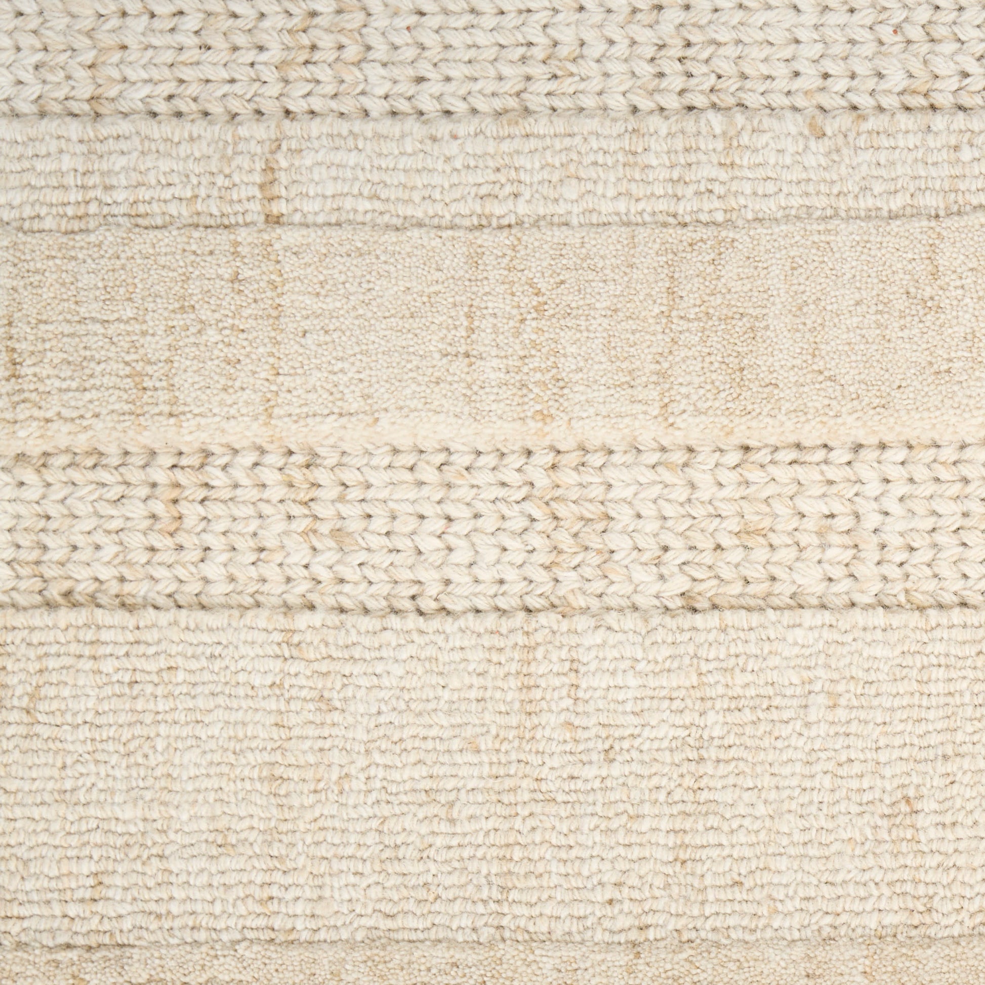 Beige woven rug with alternating textured stripes and braided boucle bands for neutral decor.