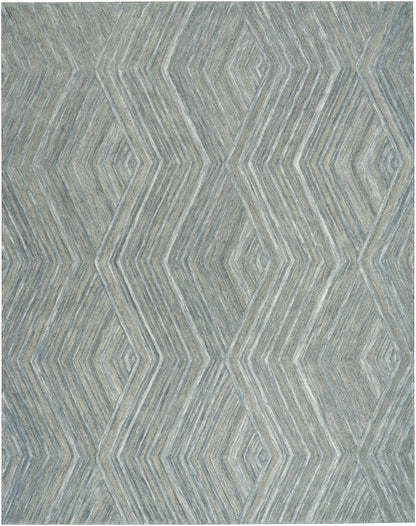 Blue-gray geometric rug with layered diamond chevron pattern and textured weave.