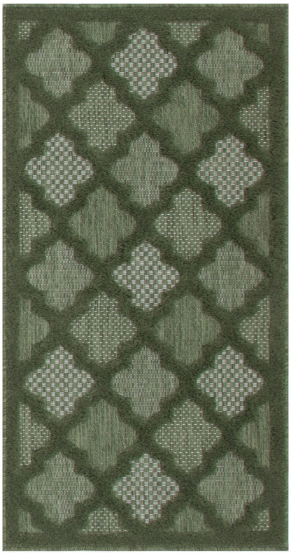 Olive green area rug with a dark lattice quatrefoil pattern and textured woven panels.