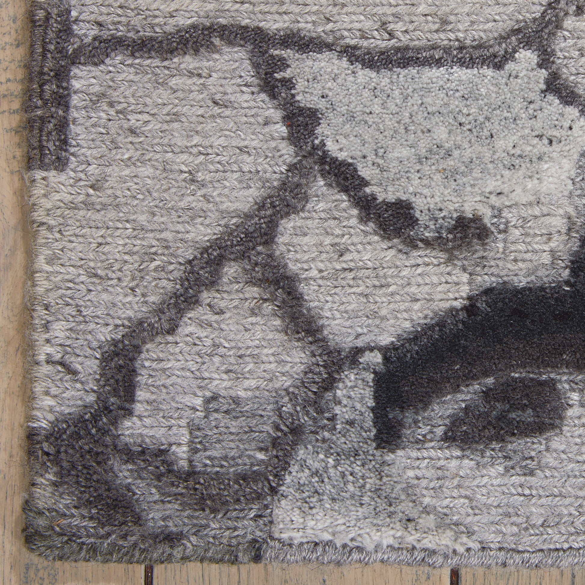Neutral grey and charcoal abstract-pattern shag rug with plush pile and dark border.