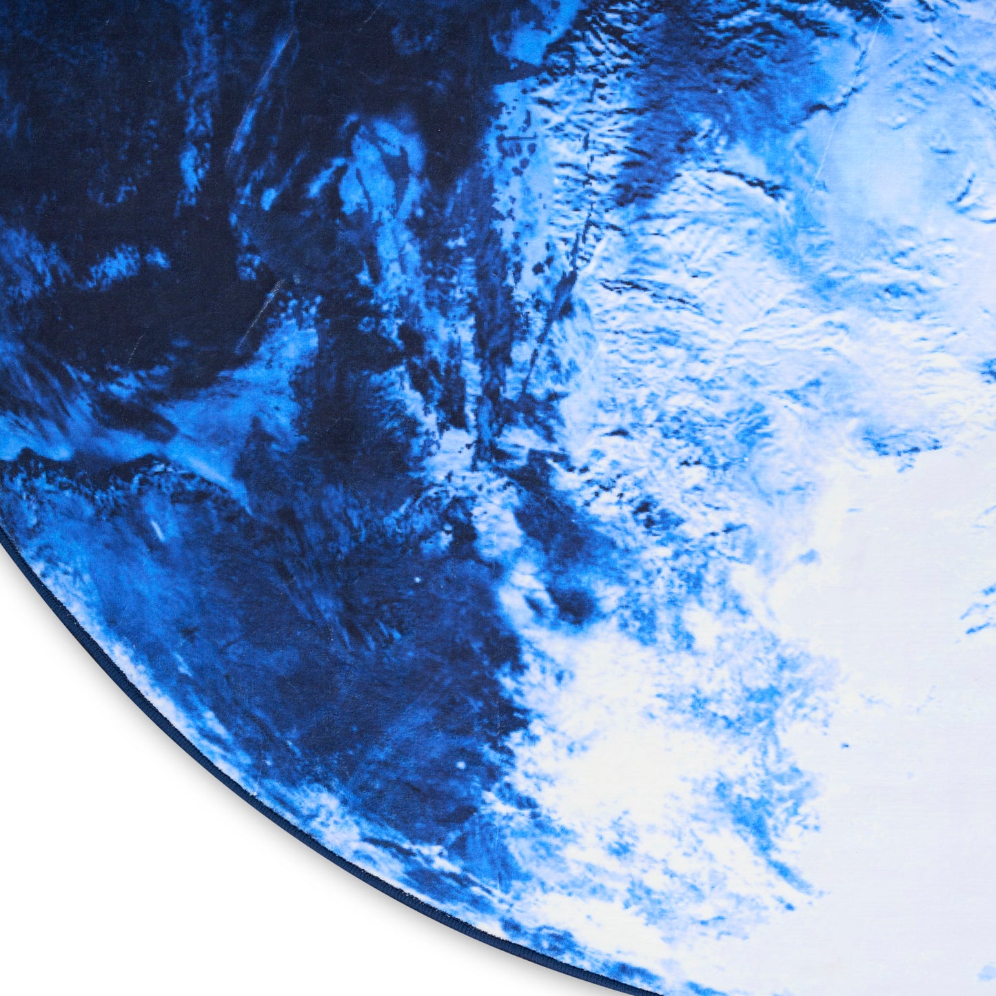 Round blue Earth-like print with dark-to-light marbling; curved edge visible, suitable as wall art or decorative rug.