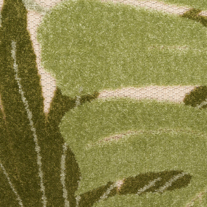Outdoor rug in olive and sage green with abstract botanical shapes on a beige woven base; textured.