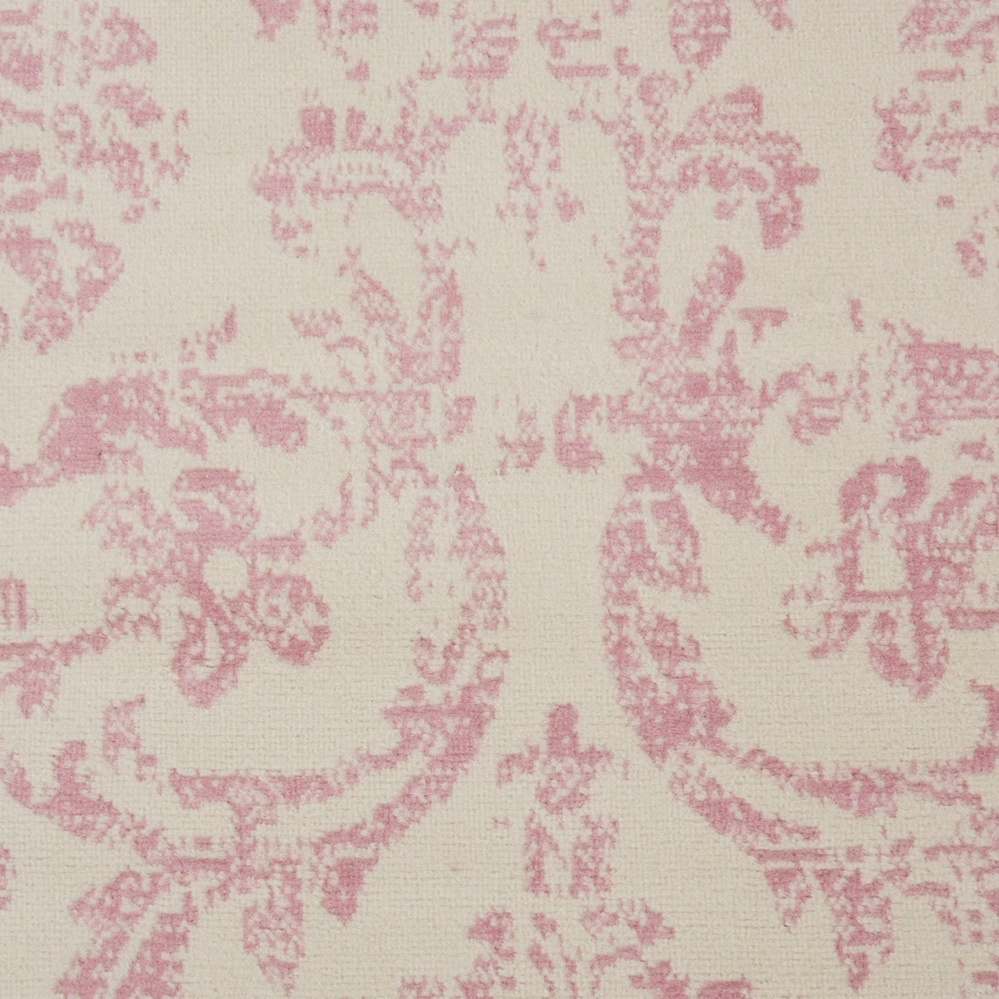 Cream background with pink damask floral pattern on a vintage 7' x 10' rug.