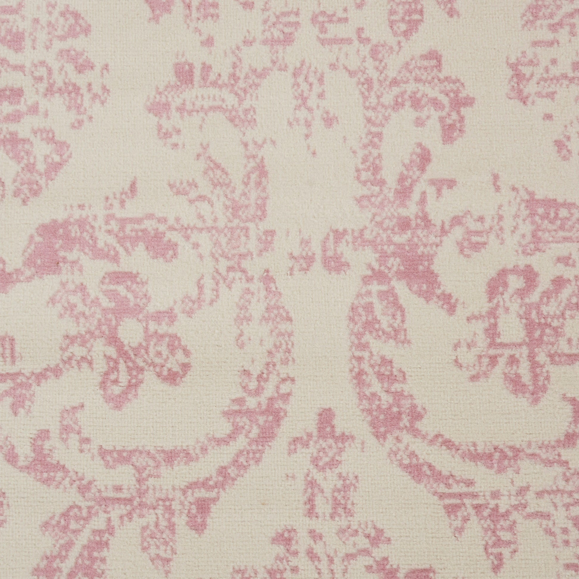 Cream background with pink damask floral pattern on a vintage 7' x 10' rug.