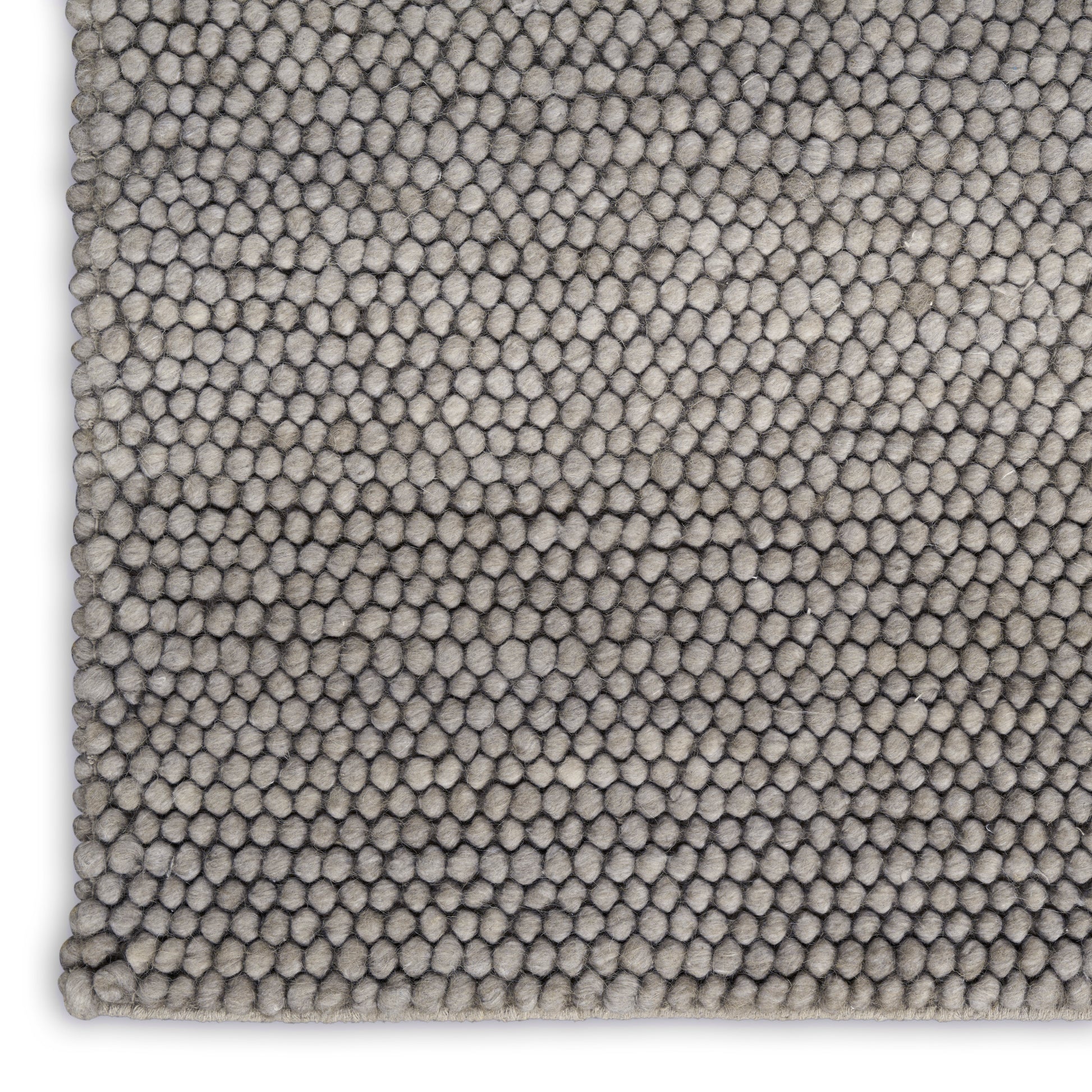 Close-up of a soft taupe gray loop-pile rug (9' x 12') with dense pebble texture and visible edge.