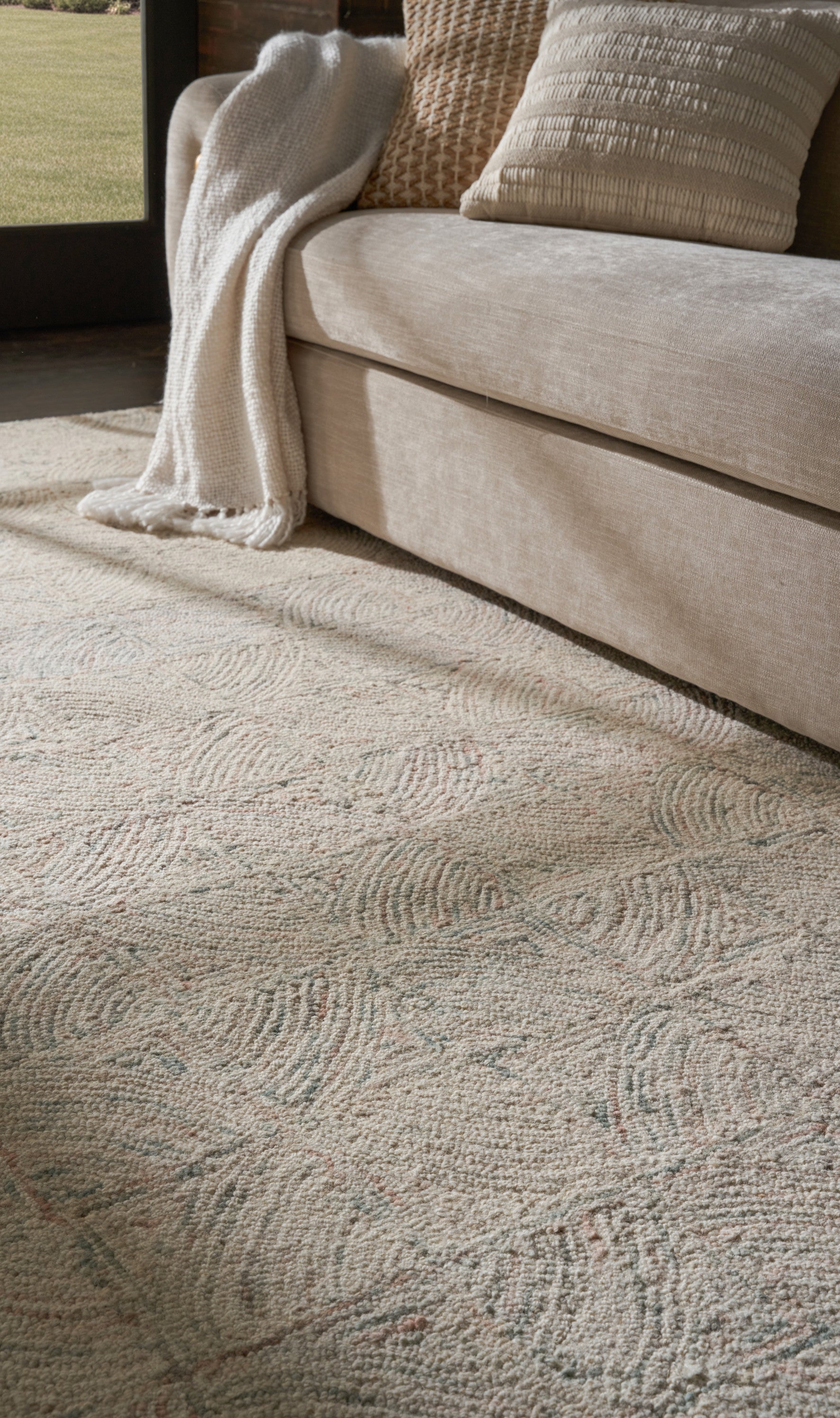 Beige rug with a light, subtle pattern in a cozy living room.