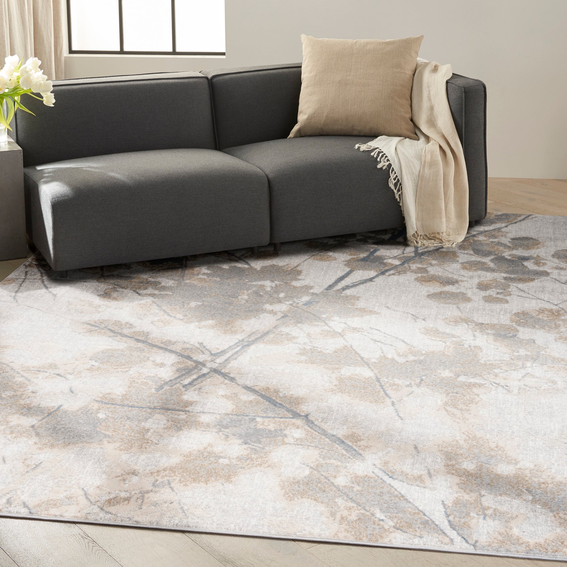 Cream-beige abstract area rug, 8' x 10', laid in a modern living room.