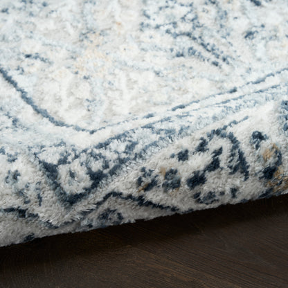 Plush shag area rug in blue & white with geometric border; cozy, modern accent for living rooms.