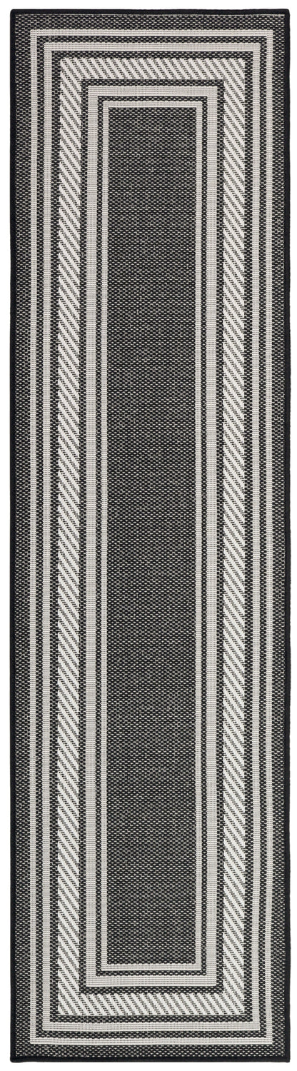 Black & ivory woven runner rug with concentric rectangular border pattern; ideal hallway decor.