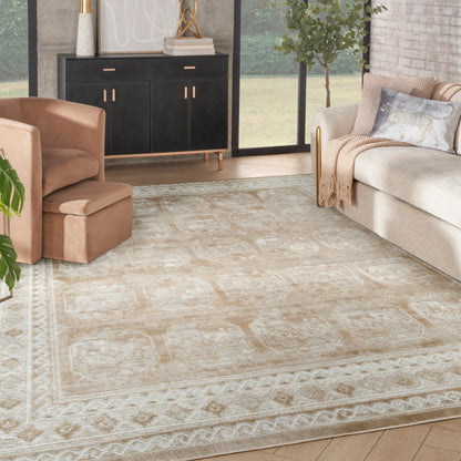 Beige patterned rectangular area rug in a modern living room with a tan armchair, cream sofa, and black sideboard.