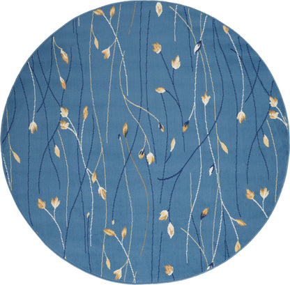 Round blue rug with slender white and gold botanical stems and leaves, modern abstract textile.