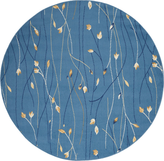Round blue rug with slender white and gold botanical stems and leaves, modern abstract textile.