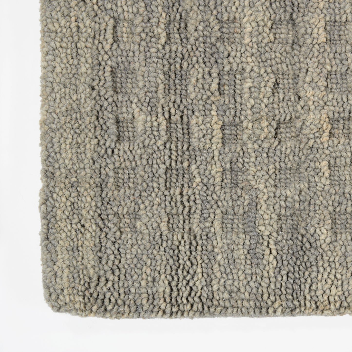 Grey-beige boucle rug with chunky loop pile and subtle abstract pattern; soft, textured floor covering.