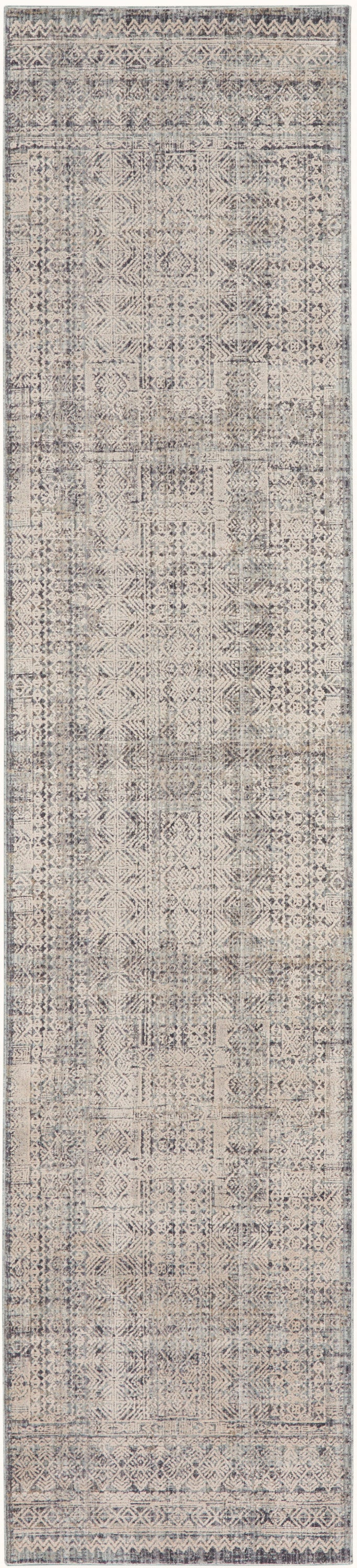 Narrow distressed beige-gray runner rug with vintage patchwork geometric motifs and soft border detailing.