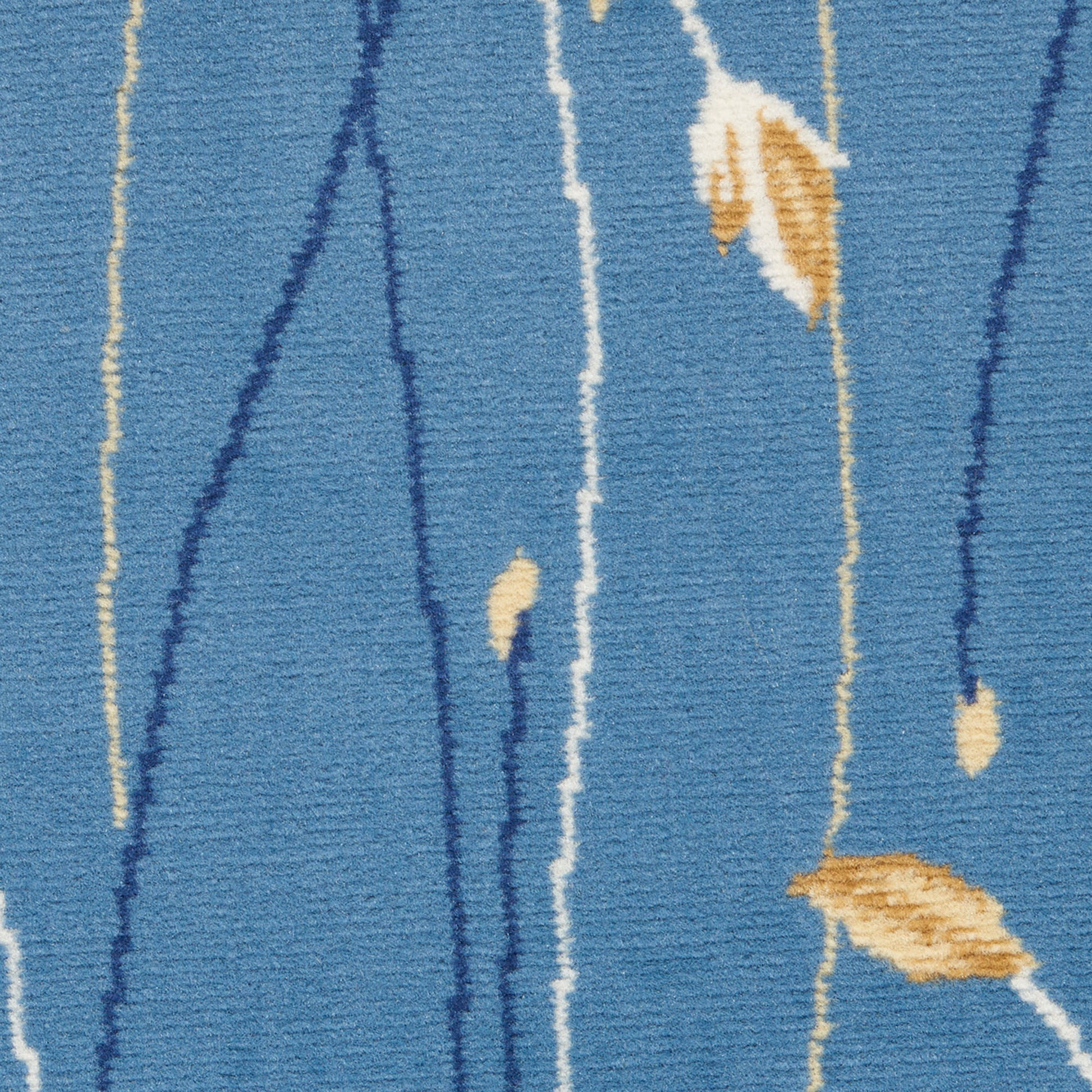 Blue textured rug with abstract vertical stems in cream and navy and tan leaf accents, woven pile.