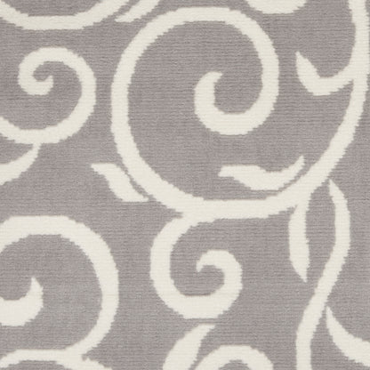 Gray rectangular area rug with white swirling scrollwork pattern, plush pile, modern decorative living room accent.