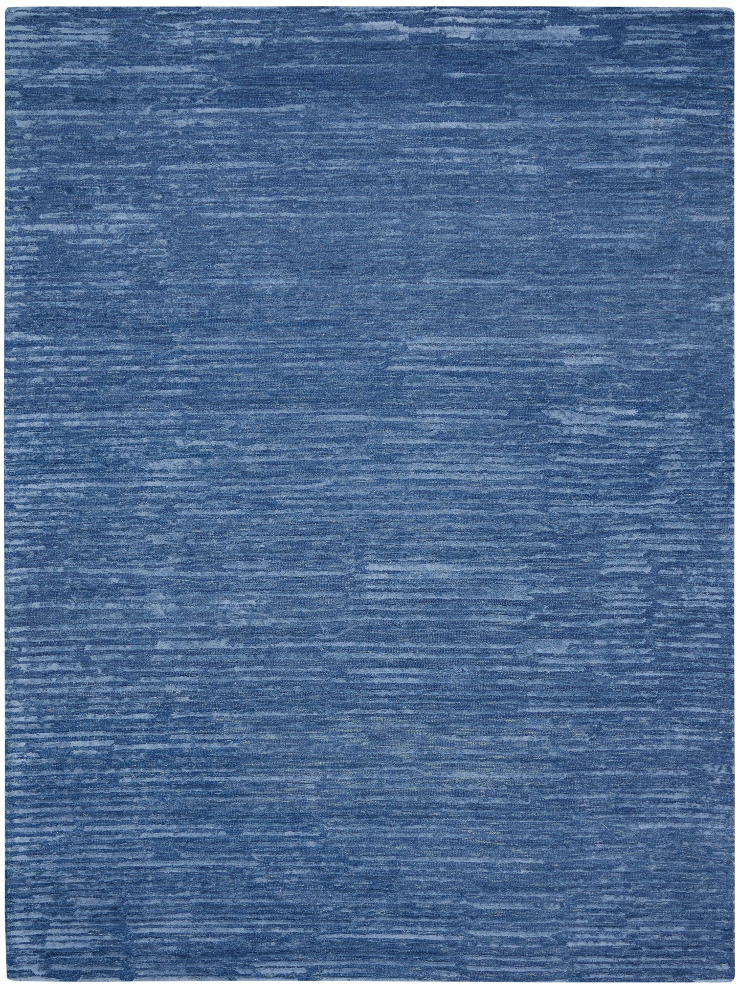 Blue distressed area rug with denim-like brushed texture and subtle lighter streaks.