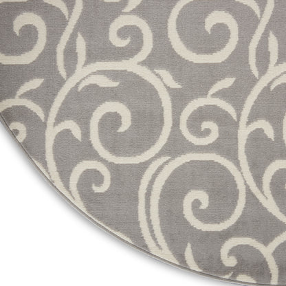 Round gray rug with white scrollwork pattern, soft textured pile for living room decor