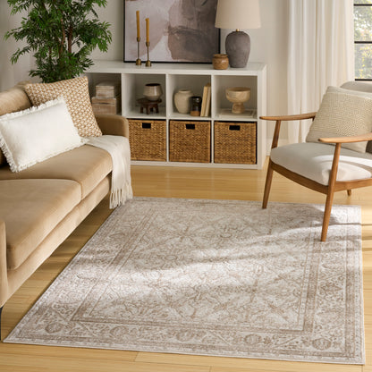 Beige sofa, wooden chair, light gray patterned rug in a sunny living room with white cubby storage & wicker baskets.
