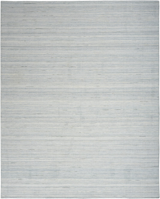 Soft blue-gray area rug with subtle horizontal stripes and woven texture in a modern minimalist style