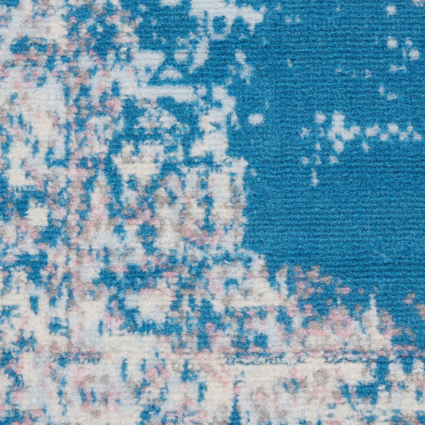 Blue distressed runner rug with ivory and pink speckled pattern; soft woven textile for floor decor.