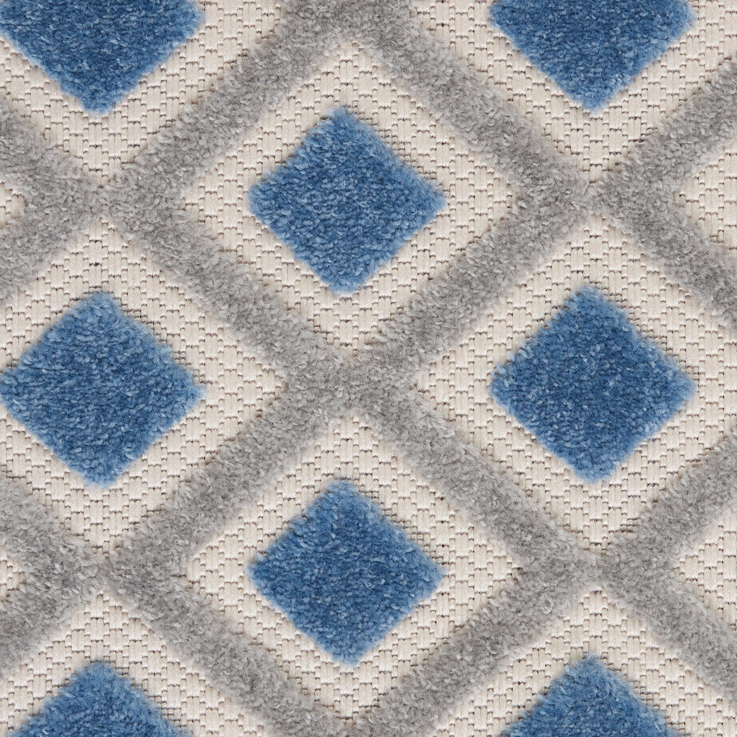 Blue diamond-pattern rug with gray lattice lines on a beige woven background; soft, textured surface, 3' x 4'.