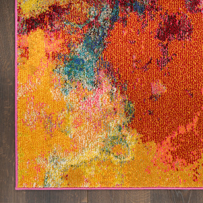 Vibrant abstract area rug with yellow, orange, pink and blue color blocks; pink edge border on a wooden floor.