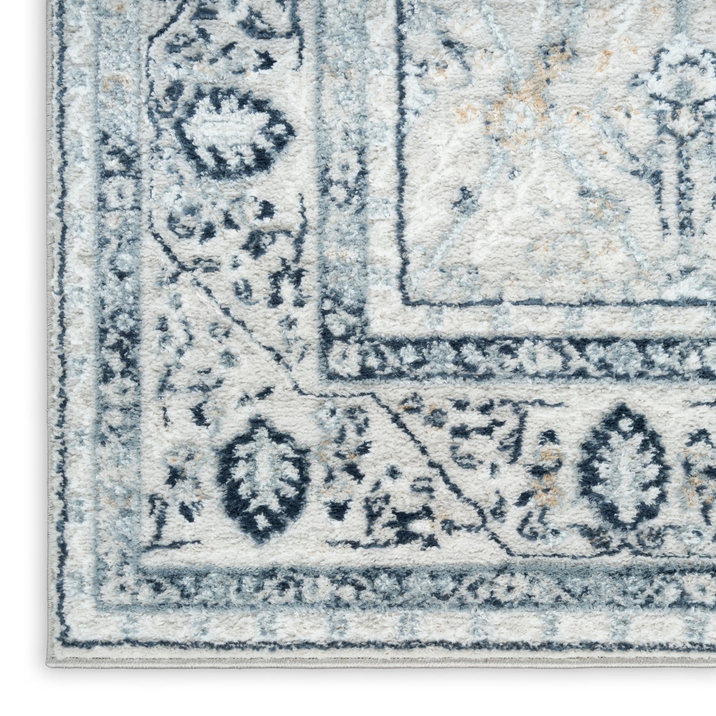Blue and ivory Persian-style area rug with floral border, plush textured pile.