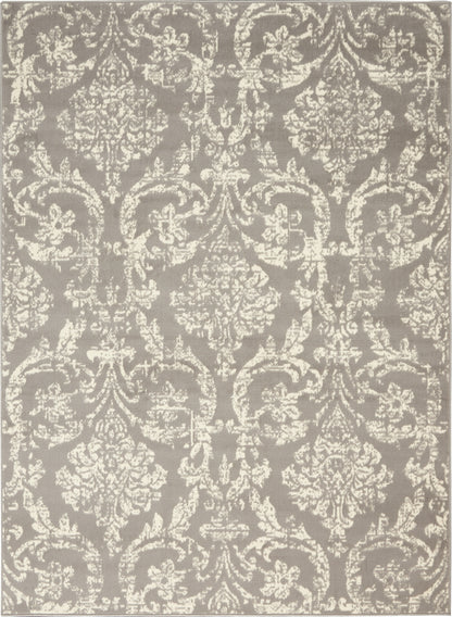 Taupe rug with ivory damask pattern and ornate floral scroll motifs.