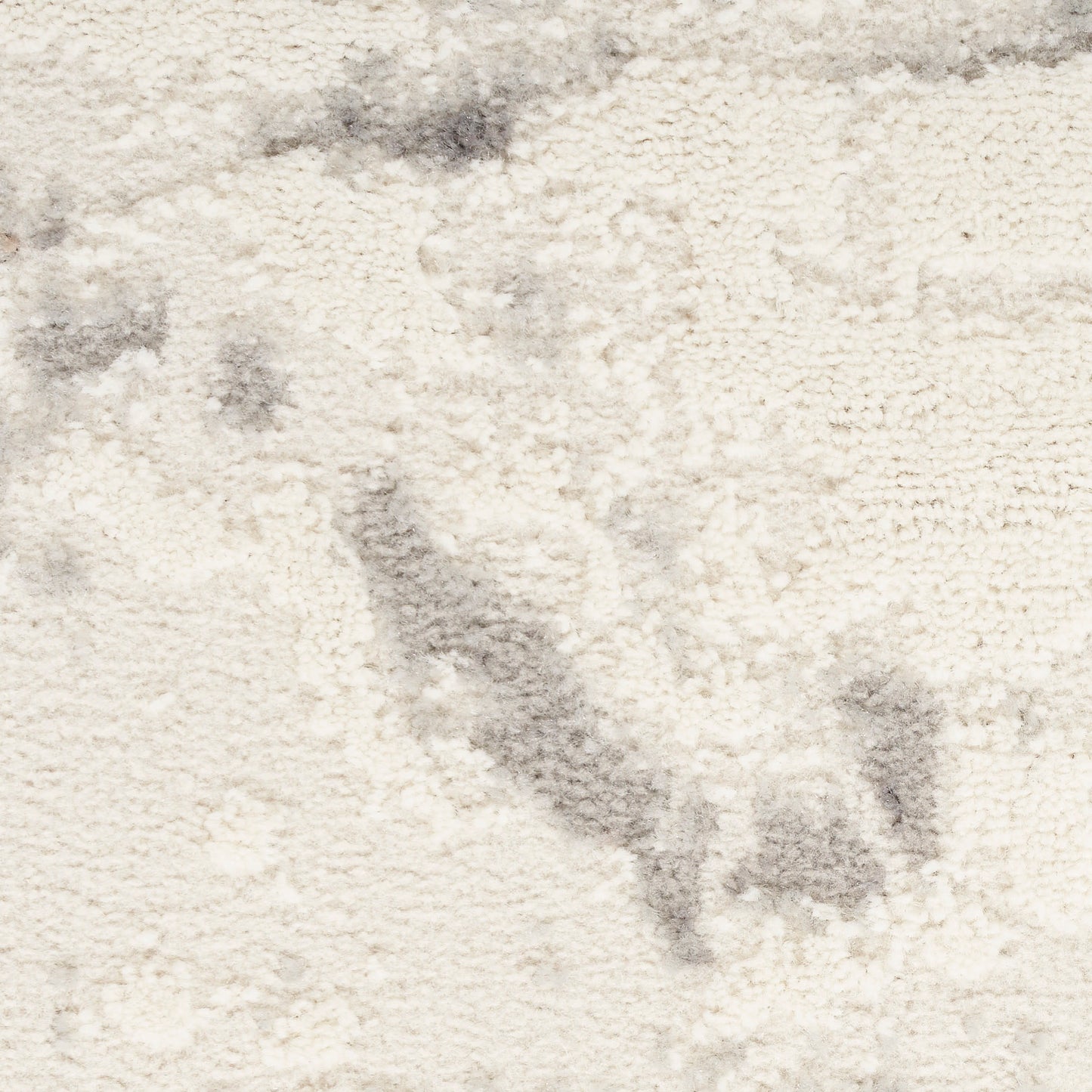Cream shag rug with plush texture and subtle gray marbling, ideal for cozy living areas.