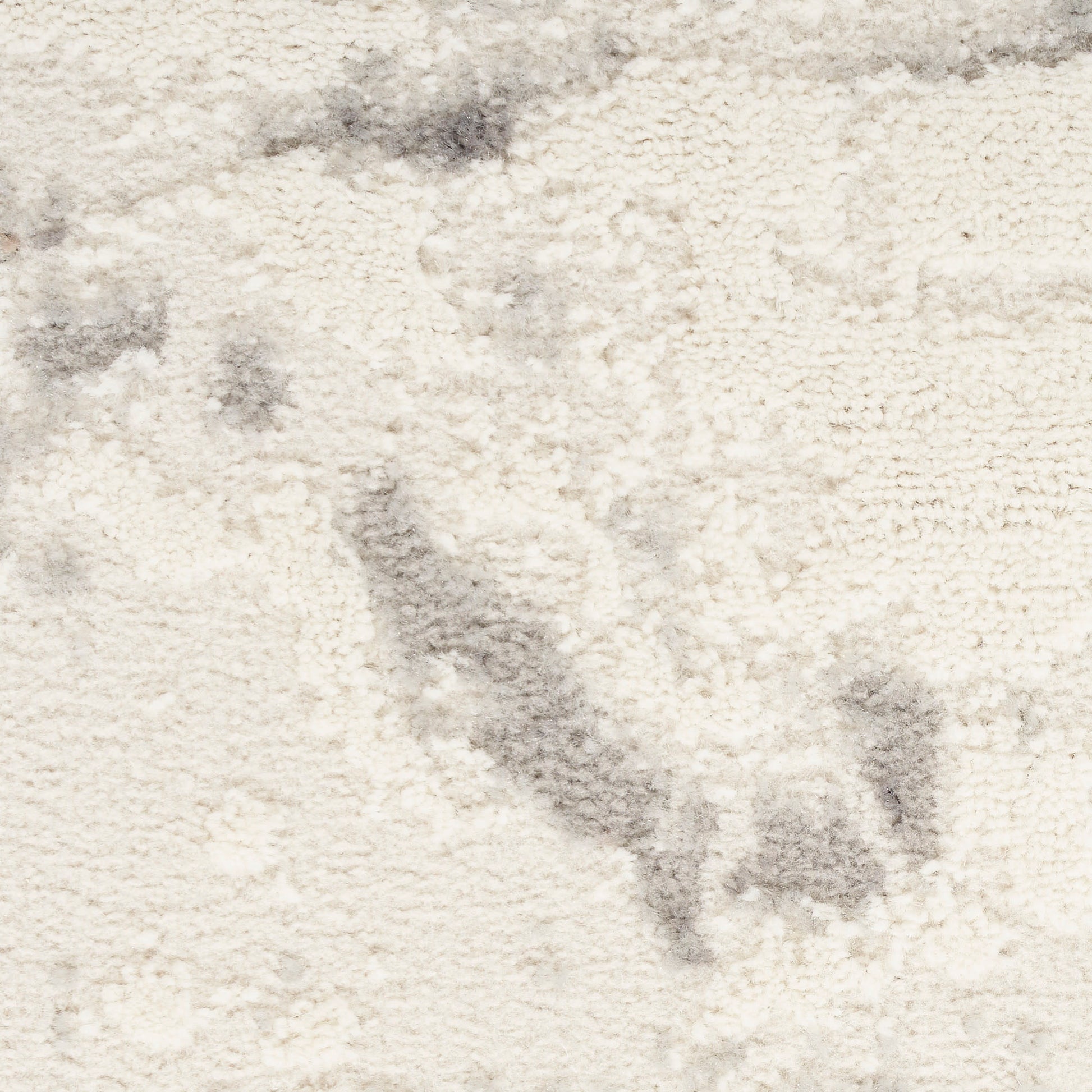 Cream shag rug with plush texture and subtle gray marbling, ideal for cozy living areas.