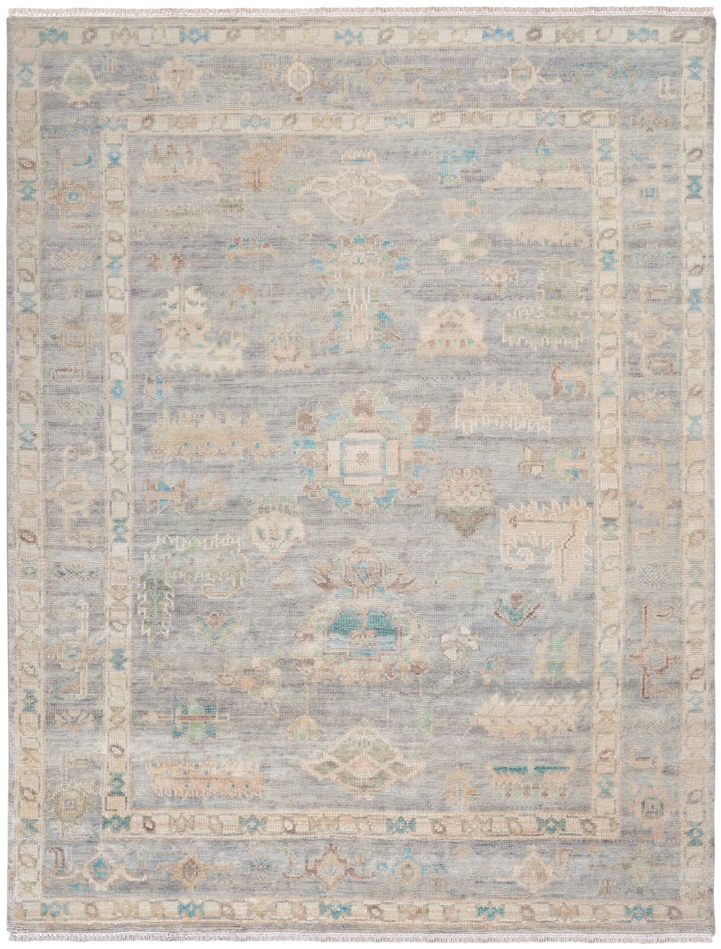Soft blue-gray oriental-style rug with ivory border, pastel accents, fringed ends; traditional decorative area rug.