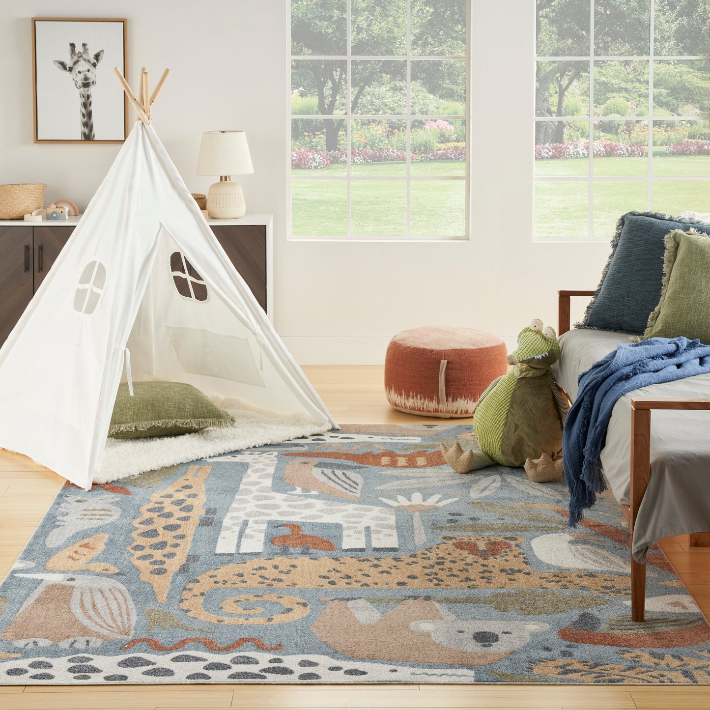 White teepee tent, wooden poles, in a cozy playroom; animal-pattern rug, green plush crocodile, orange pouf, blue-throw sofa.