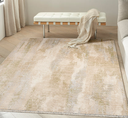 Neutral abstract area rug in beige, cream, sage & pale blue with fringed edges in a modern living room