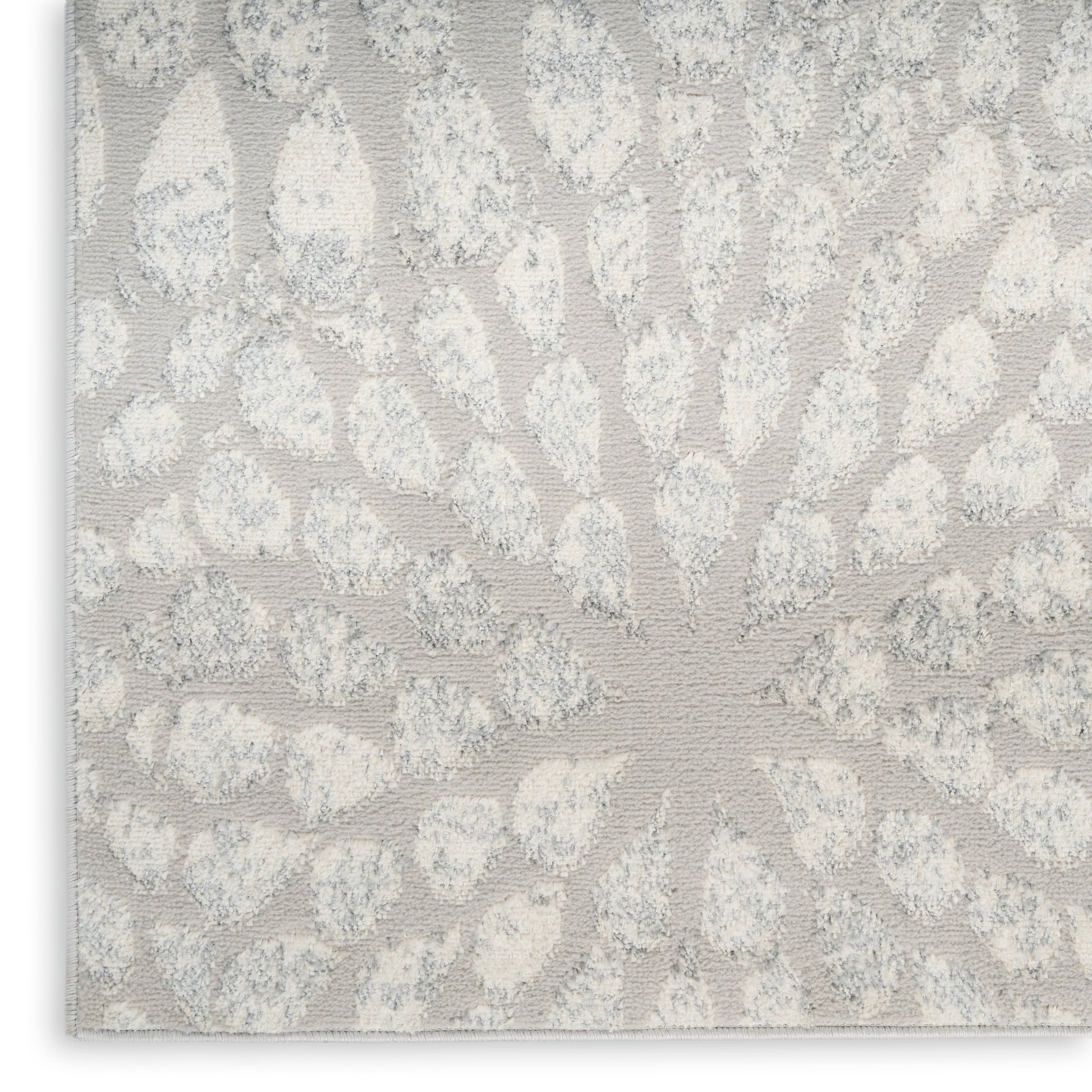Light gray jacquard rug with ivory sunburst damask pattern; textured surface in a modern 8' x 10' rug.