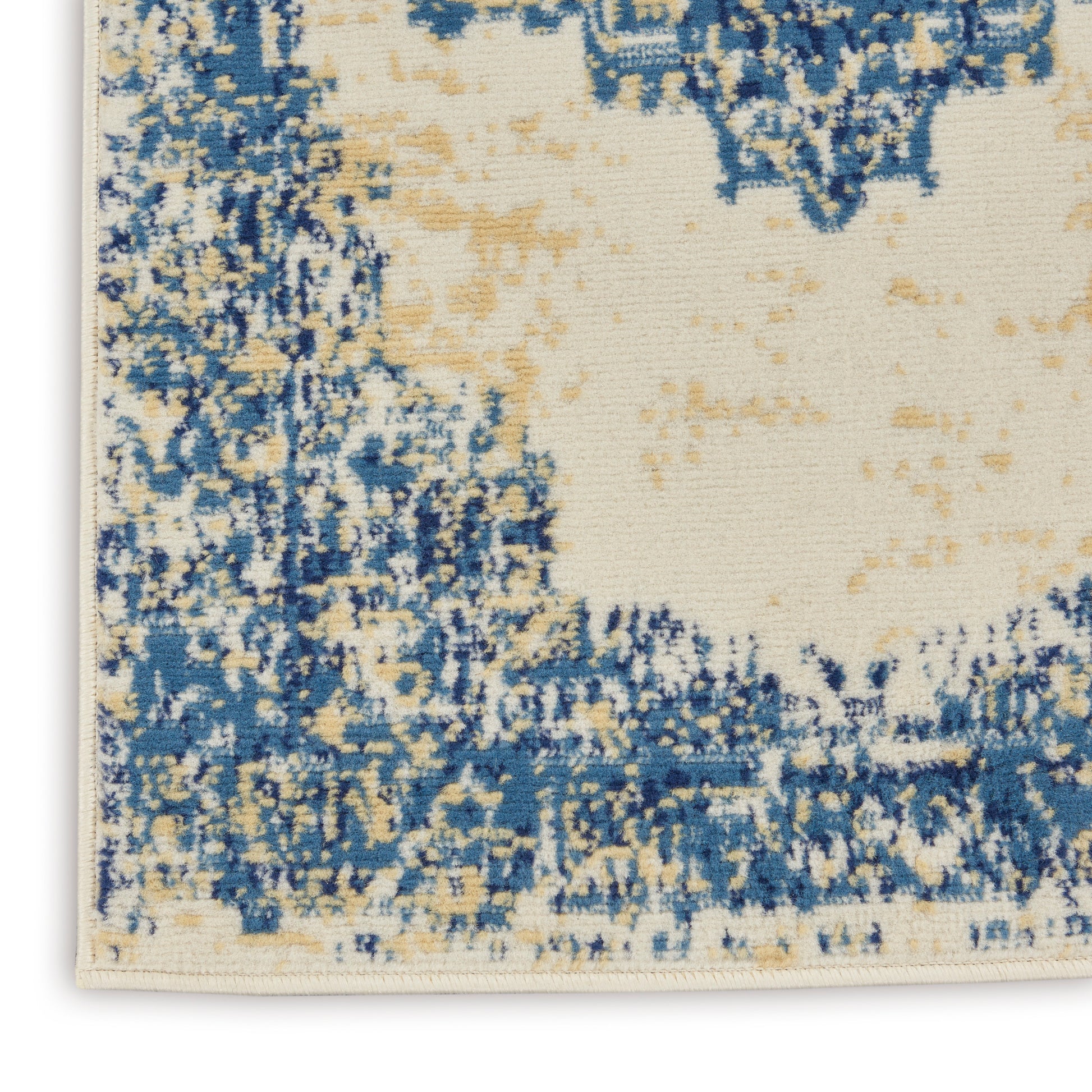 Abstract blue and beige 8' runner rug with cream background and distressed pattern.