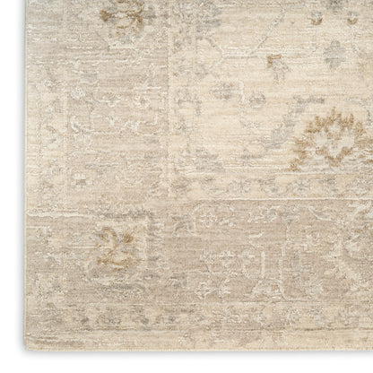 Beige distressed vintage rug with muted cream and taupe floral pattern; rectangular, soft-neutral decor.