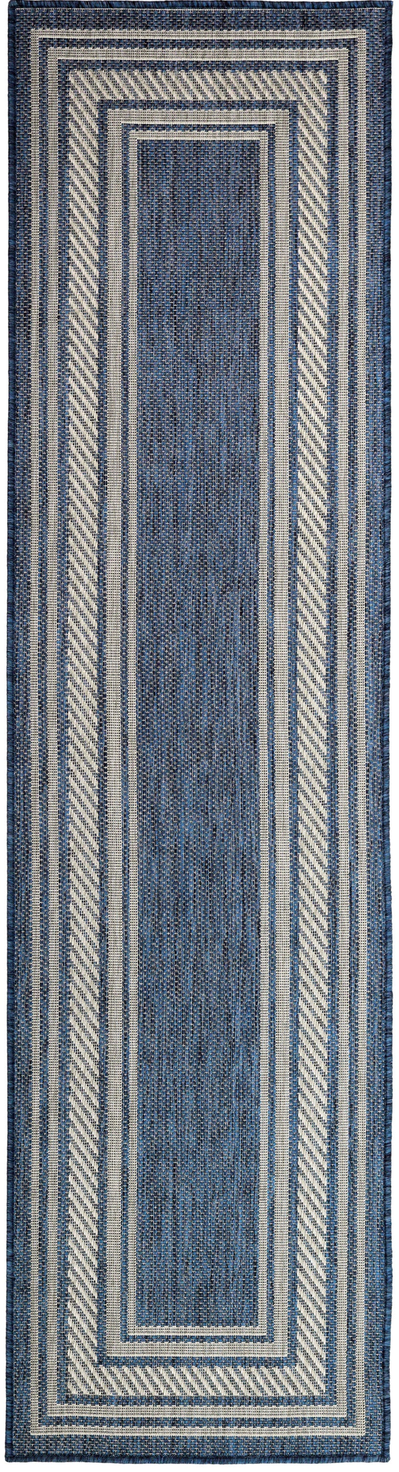 Indigo blue woven runner rug with ivory layered borders and diagonal striped accents.