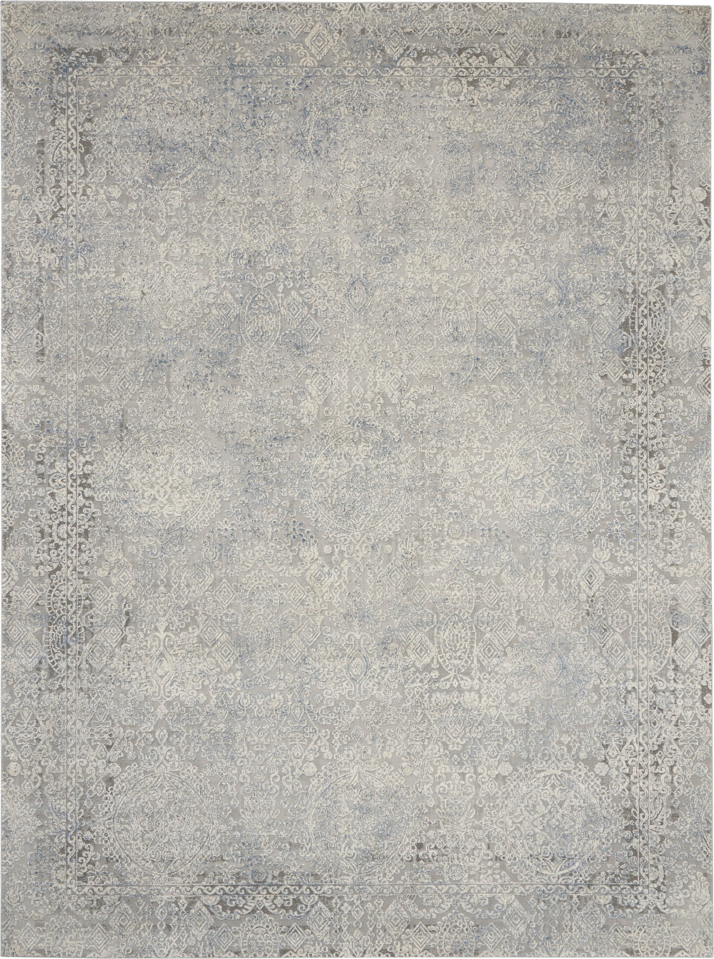 Rectangular distressed gray-blue oriental area rug with faded floral medallion pattern and decorative border.