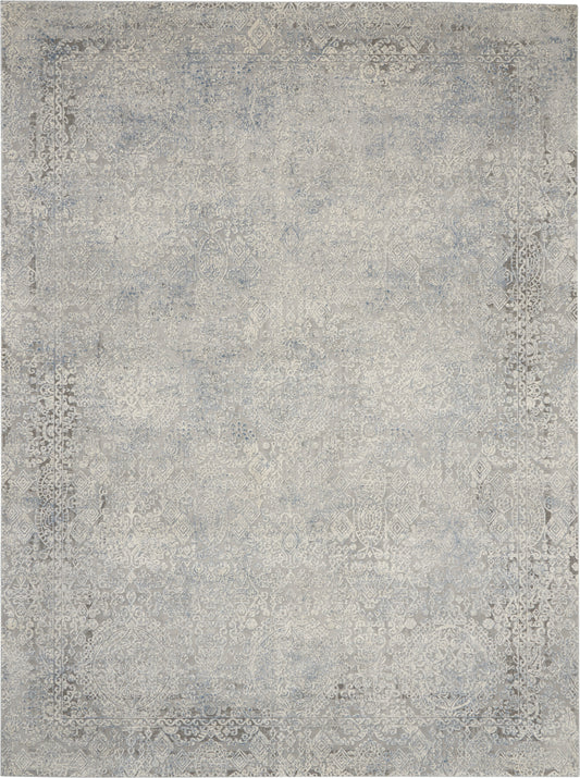 Rectangular distressed gray-blue oriental area rug with faded floral medallion pattern and decorative border.