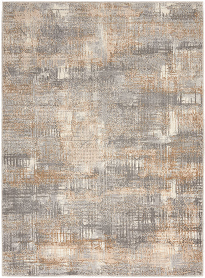 Abstract soft-pile area rug in gray, beige and tan with painterly, grid-like patchwork patterns.