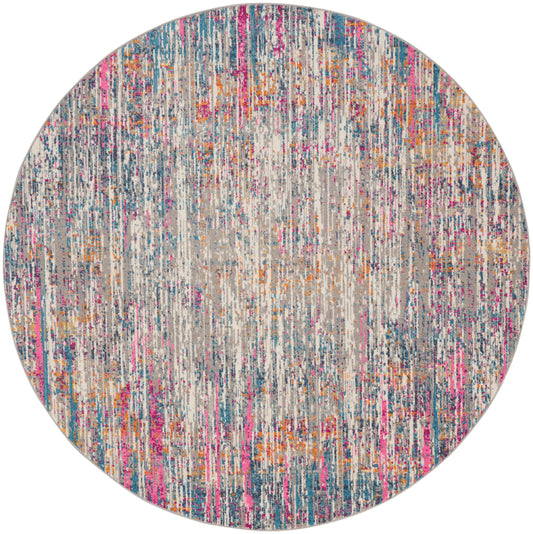 Round gray rug with multicolor vertical streaks in pink, blue, and orange.
