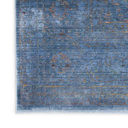 Blue distressed oriental area rug with vintage faded gold/brown motifs and a fringed edge.