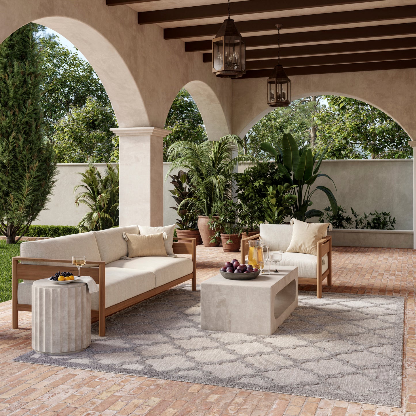 Outdoor Mediterranean patio with cream-cushioned wooden sofas, concrete coffee table, arched columns, potted plants, brick floor.