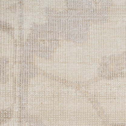 Beige woven rug with subtle cream damask pattern; soft, textured textile for living room decor.