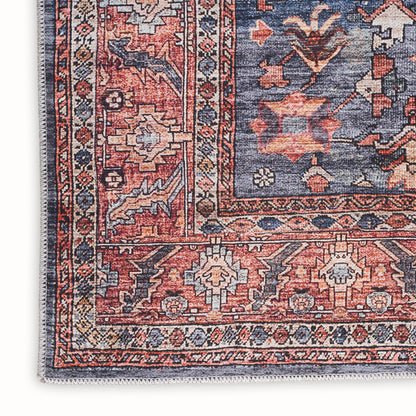Persian-style Oriental rug corner, red and navy field with ivory borders and geometric floral motifs; fringed edge.