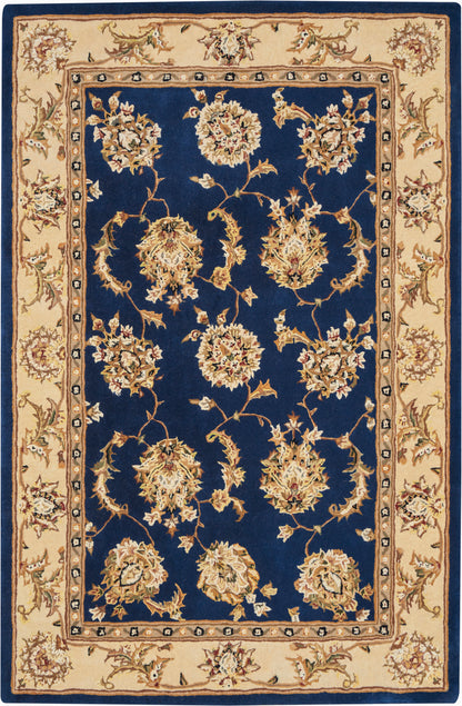 Rectangular Persian-style rug with navy field, cream border and gold floral medallions along scrolling vines.